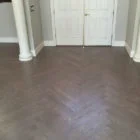 patterned dark hardwood floors in entry way with white doors