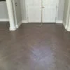 patterned dark hardwood floors in entry way with white doors