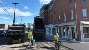 J. Hunziker Paving crew performing asphalt repair on a commercial street in the Capital Region