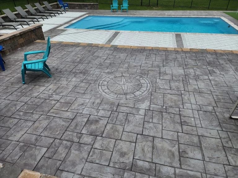 decorative concrete pool deck with custom emblem in Nashville - The Concrete Gentlemen