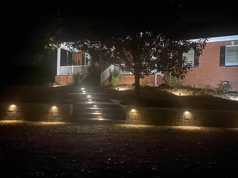 custom hardscaping job lit up at night in Nashville - The Concrete Gentlemen