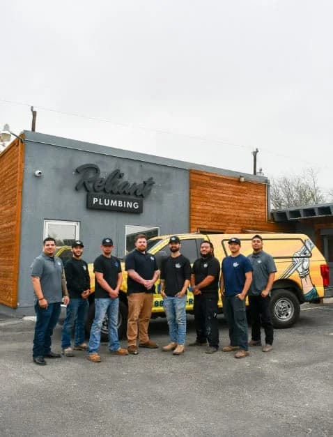Reliant Plumbing San Antonio crew posing in front of shop and work truck