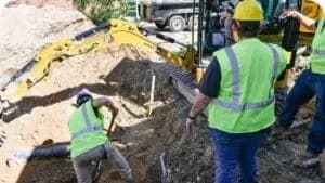workers using mechanical plumbing excavator