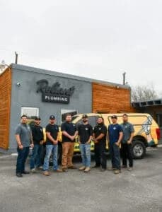 Reliant Plumbing San Antonio crew posing in front of shop and work truck