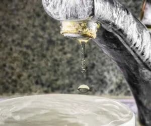 Signs of hard water buildup on a faucet