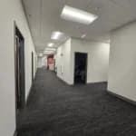 A commercial building in Cary, NC, with an interior corridor showcasing freshly painted off-white walls.
