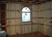 spray foam on wall with window