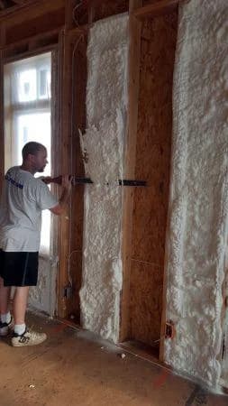 worker applying spray foam