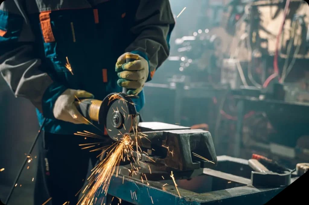 Person using angle grinder with sparks flying.