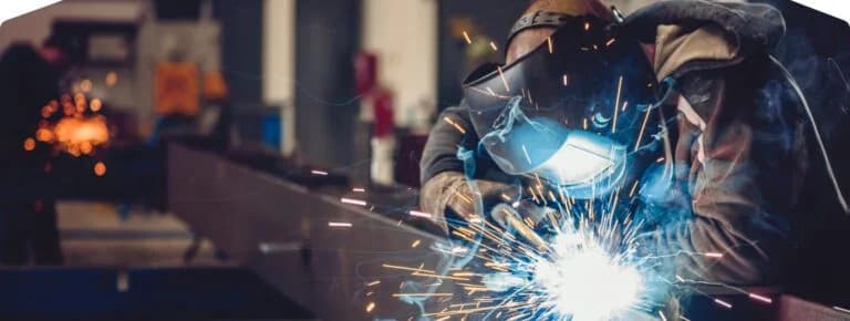 Welder sparks metal fabrication work.