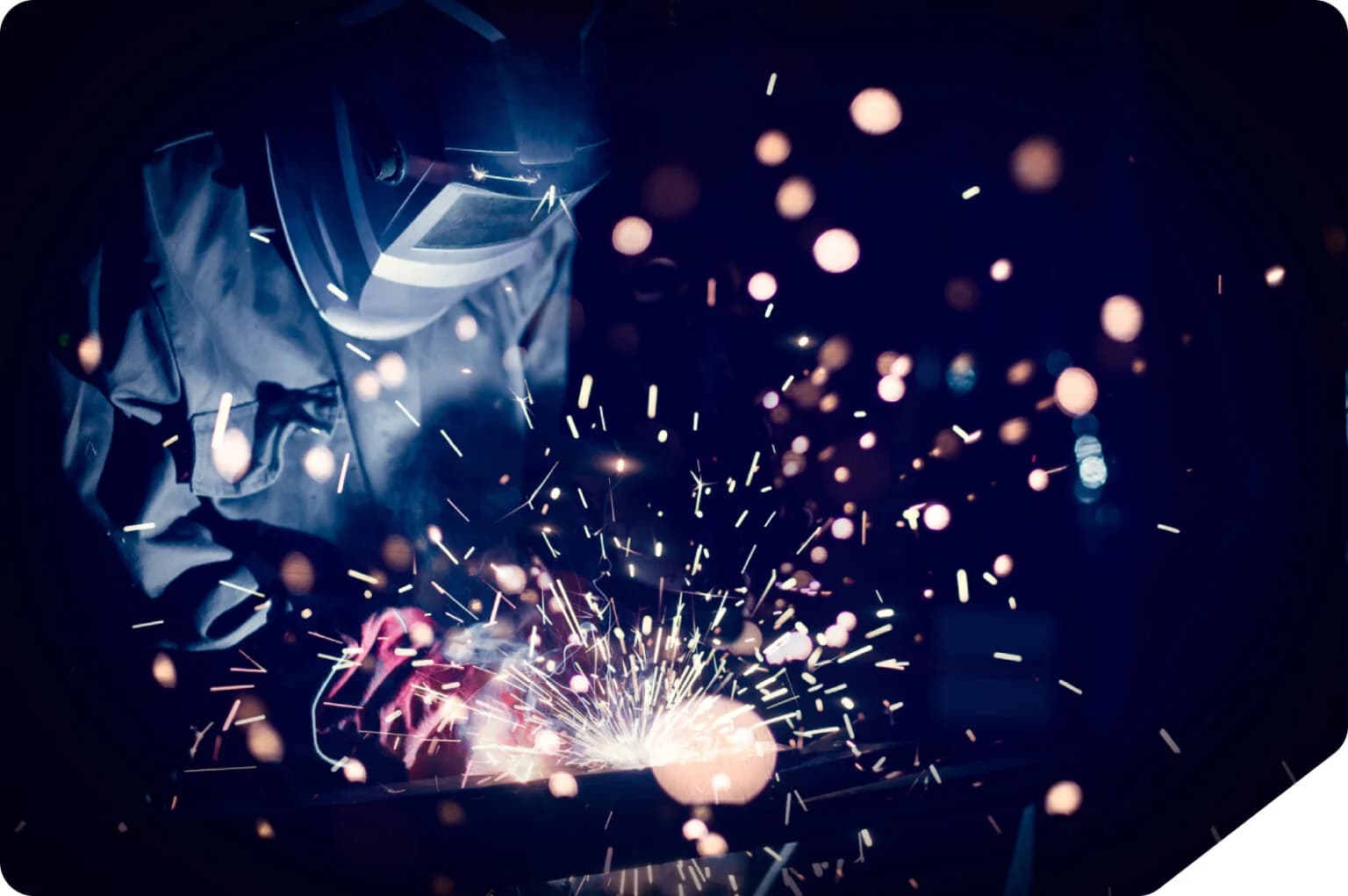 Welder sparks metal fabrication work.