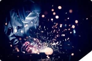 Welder sparks metal fabrication work.