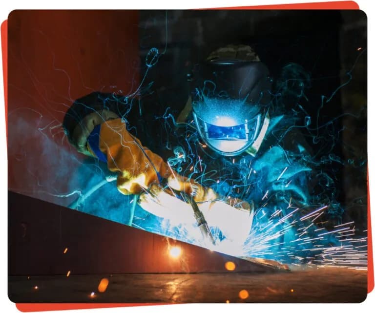 Welder sparks bright blue metal work.