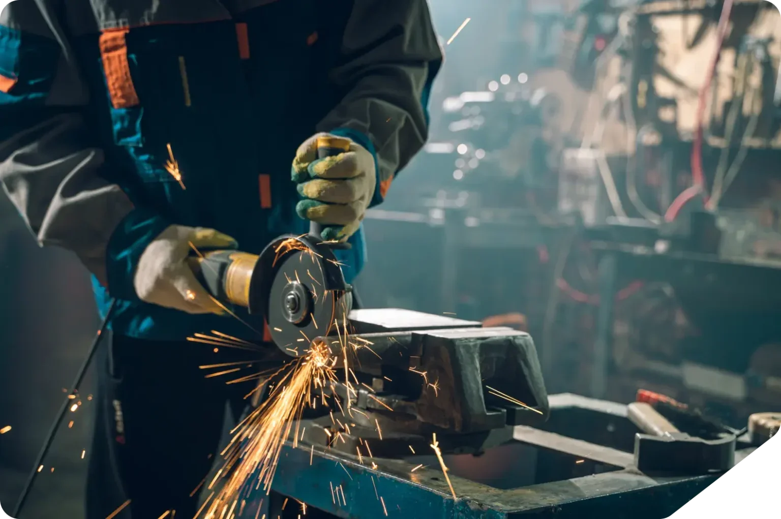 Person using angle grinder with sparks flying.