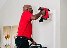 Mr. Handyman adding door molding.