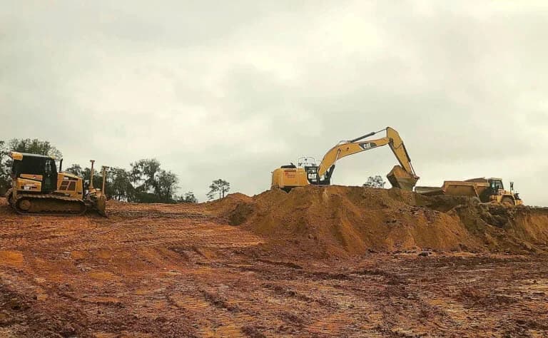 Tractors performing construction site development