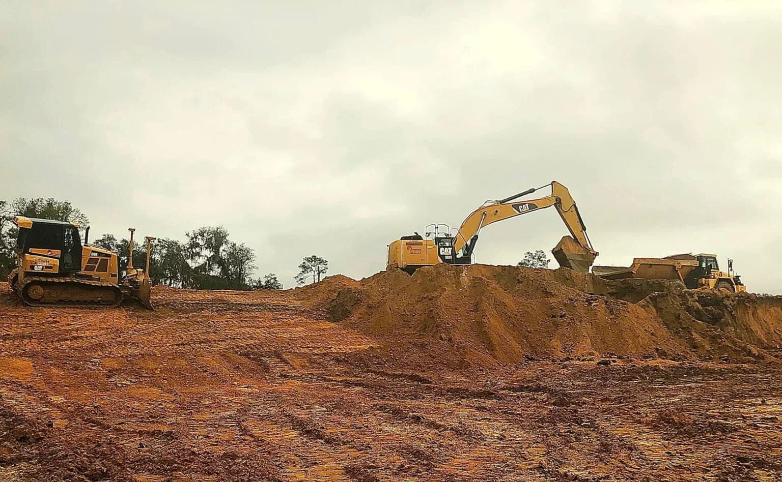 Tractors performing construction site development