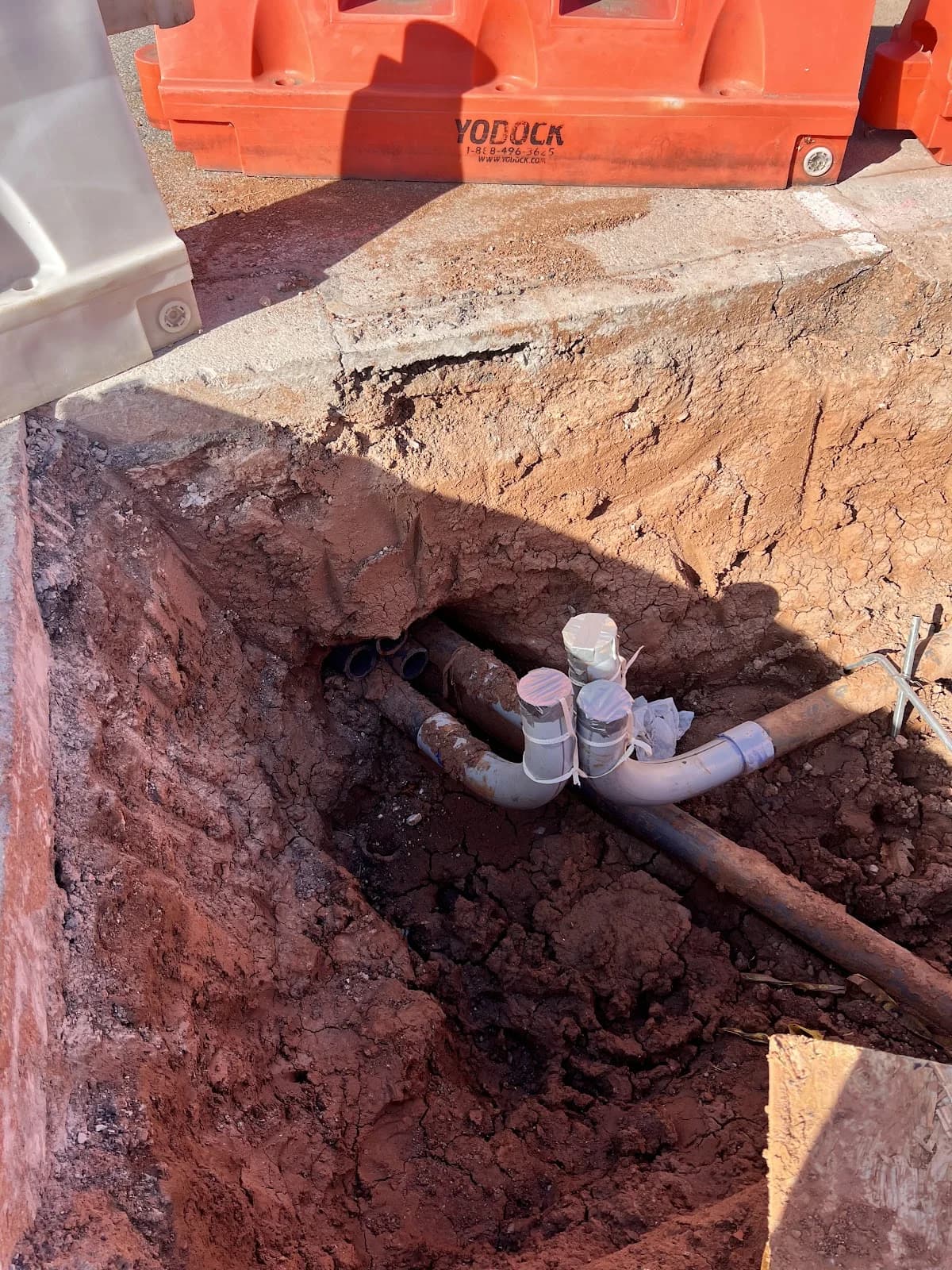 Trinity Boring Solutions pipe junction excavation Oklahoma City red clay underground utility bore connection directional drilling