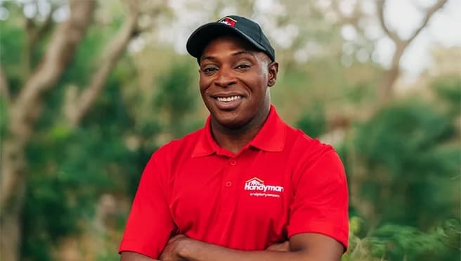 Smiling handyman with arms crossed.