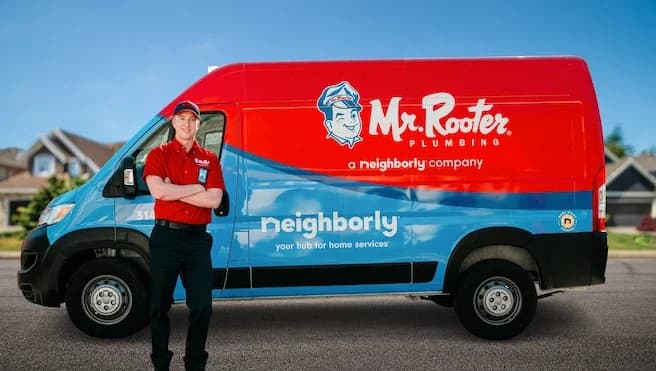 A smiling plumber in a red