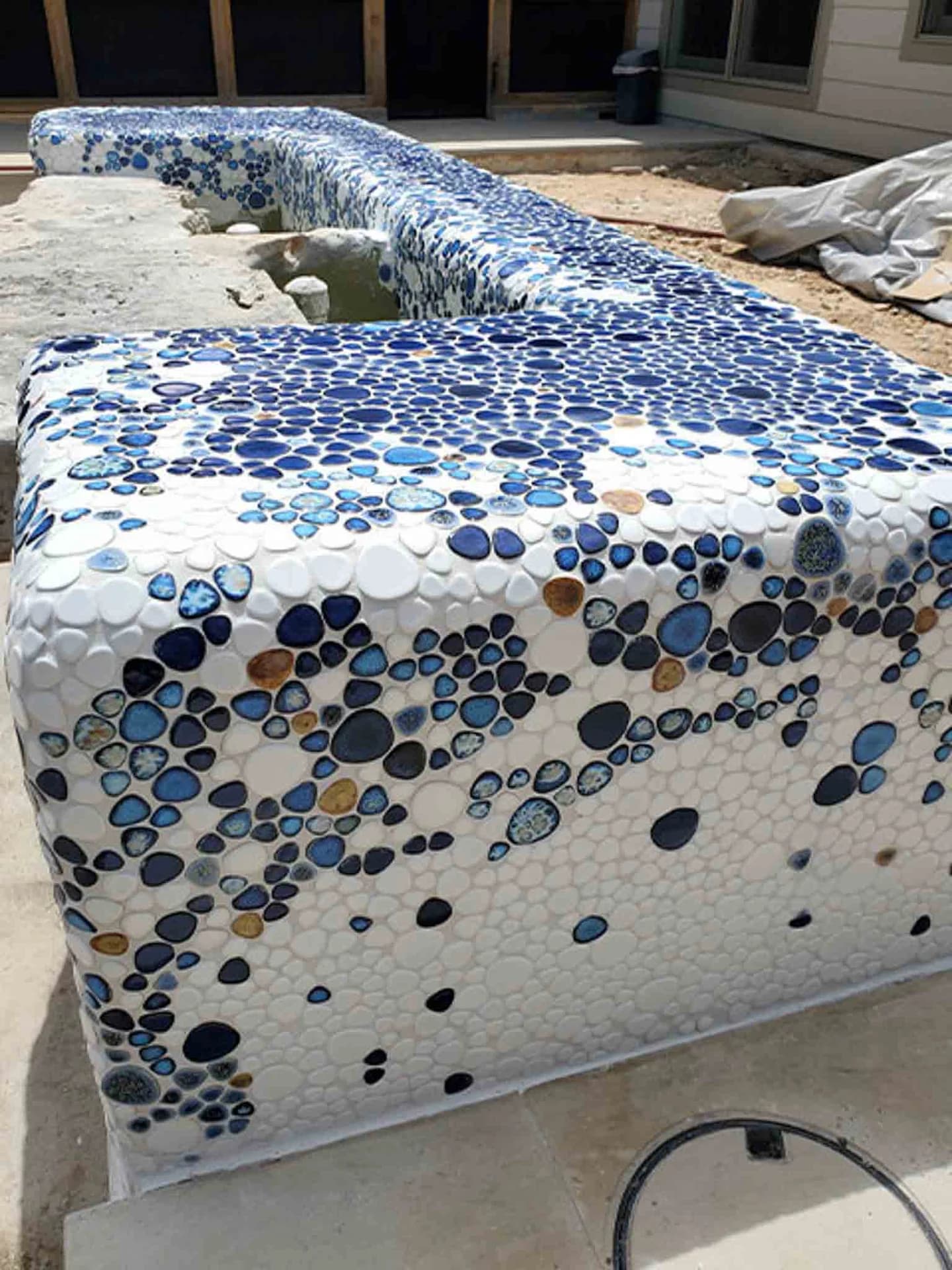 An outdoor fountain with blue tile, done by Footprints Floors.