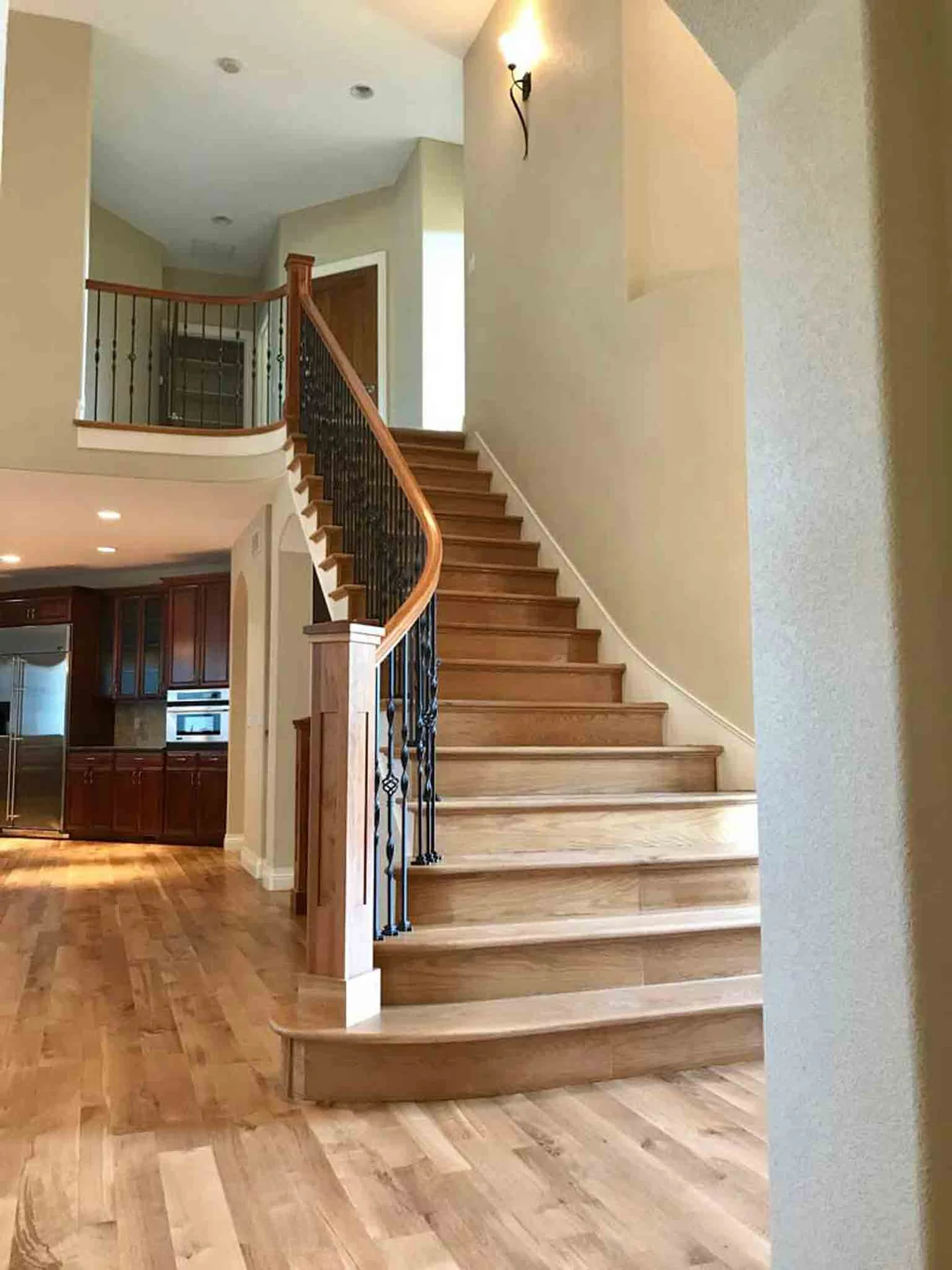 A staircase with light brown wood, installed by Footprints Floors.