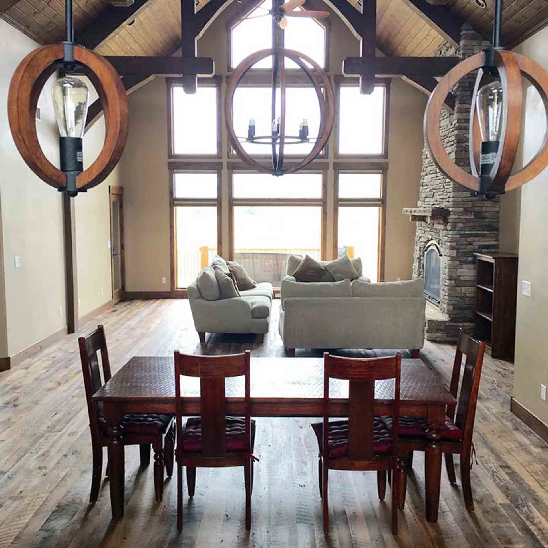 A large living room dark wood flooring by Footprints Floors.