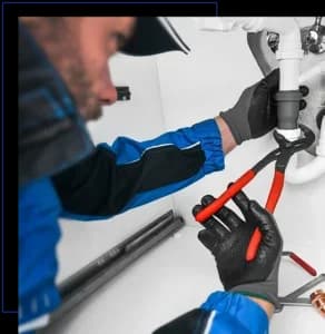 Plumber working in kitchen, Repair man service, repairing leaking water from sinks with red wrench