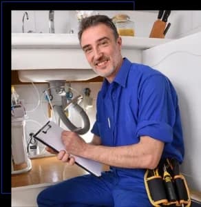 Plumbing technician checking water installation under the sink of a home kitchen with notepad.