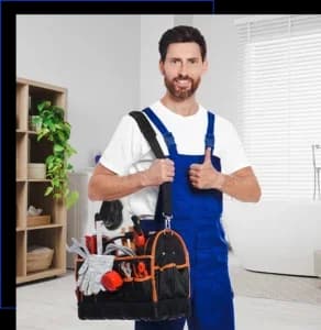 Plumber with bag of instruments showing thumbs up in bathroom