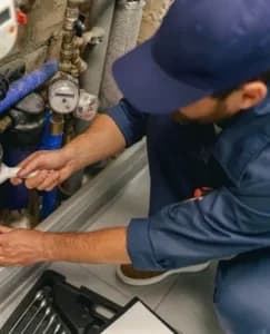 Professional plumber repairing water supply system at home uses a special tools