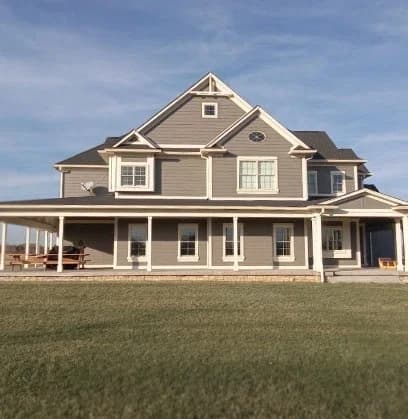 Front view of house in Indianpolis with new siding replacement (grey) courtesy of Moss Roofing.