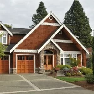 A home with fresh roofing and stone accents designed to improve curb appeal.