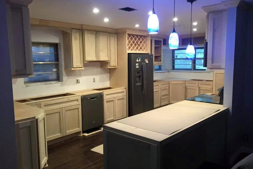 Modern kitchen remodel featuring custom cabinetry, under-cabinet lighting, and a central island, highlighting Ace Kustoms' craftsmanship and design aesthetics.