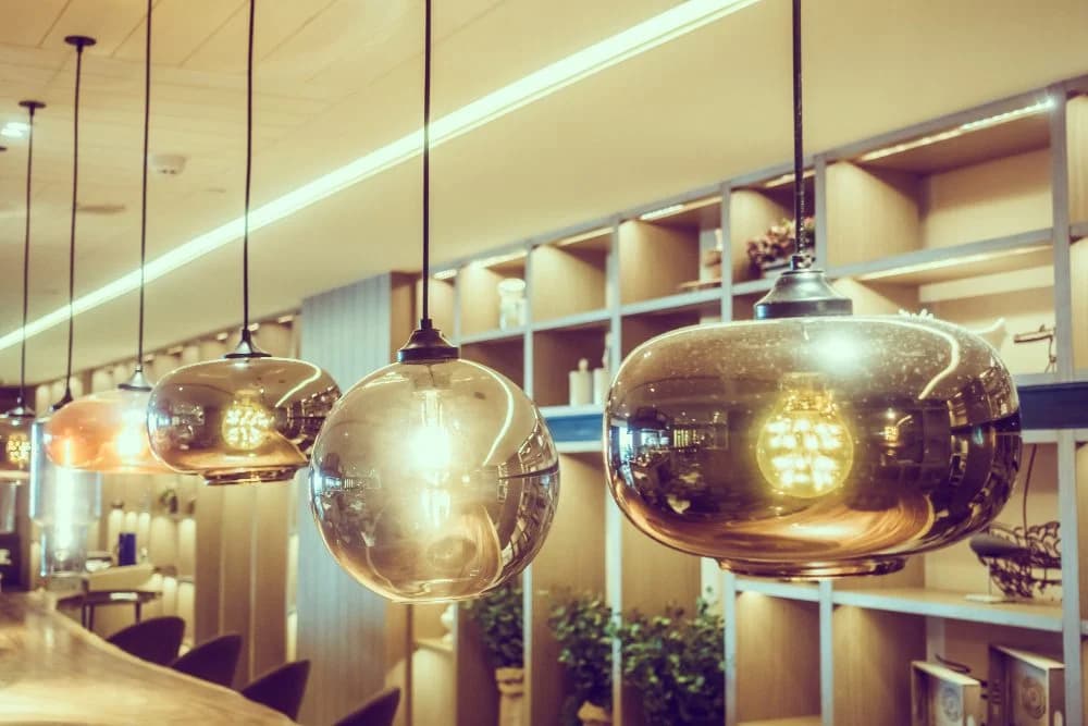 Hanging decorative pendant lights with warm illumination, enhancing kitchen ambiance and showcasing modern design elements.