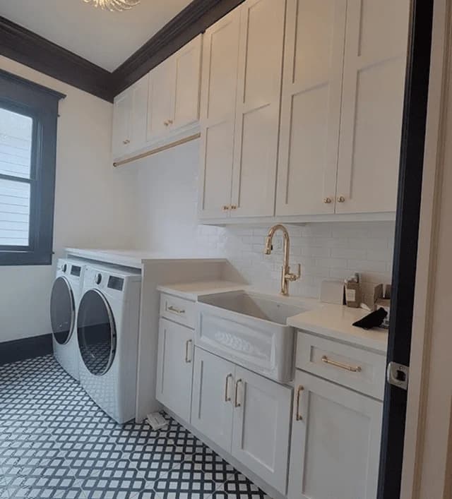 Modern laundry room design featuring white cabinetry, gold fixtures, dual washing machines, and a farmhouse sink, emphasizing custom cabinetry solutions for enhanced home functionality.
