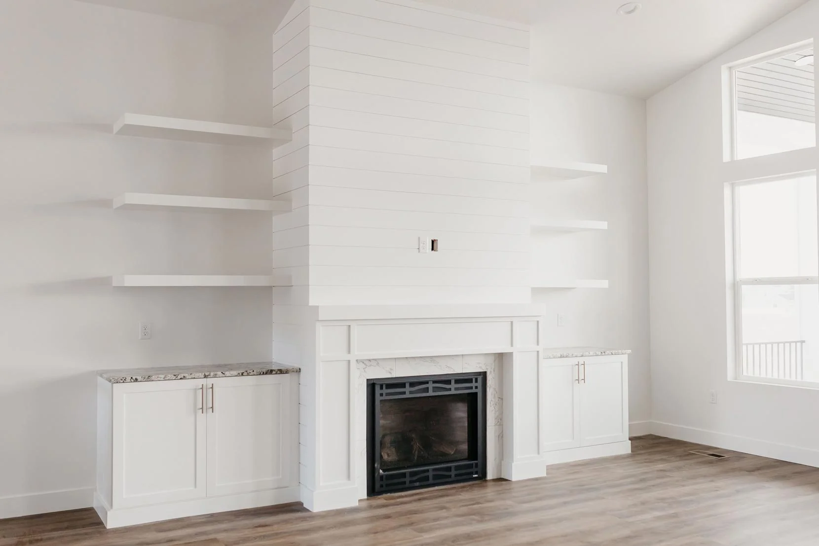 white fireplace with floating shelves by 10x builders in utah county