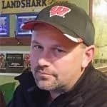 Steve Tomkiewicz wearing a Wisconsin cap, expressing satisfaction with American Foundation Specialists' foundation repair services.