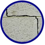 Cracked concrete wall indicating potential foundation issues, relevant to signs of home foundation repair.