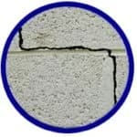 Cracked concrete wall indicating potential foundation issues, relevant to signs of home foundation repair.