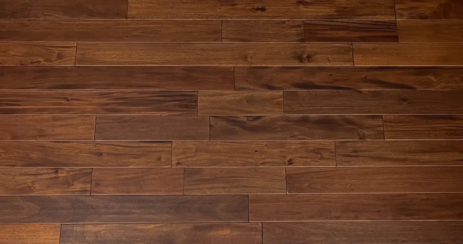 Solid mahogany hardwood floor installation showcasing rich wood grain, smooth finish, and professional craftsmanship in a residential interior.