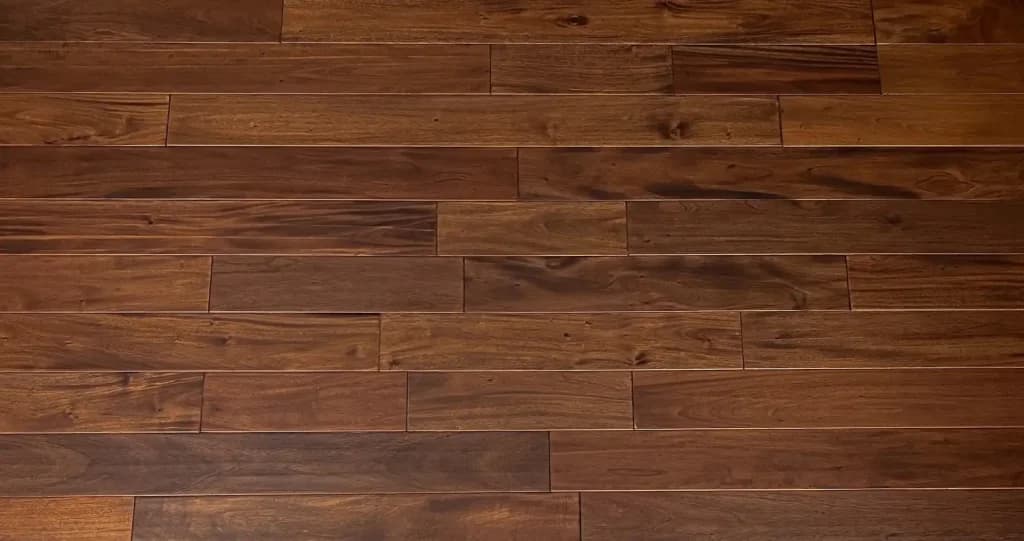Solid mahogany hardwood floor installation showcasing rich wood grain, smooth finish, and professional craftsmanship in a residential interior.