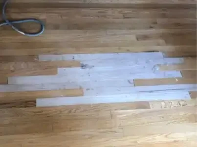 Hardwood floor repair with damaged plank replacement in a Palos Verdes residential home