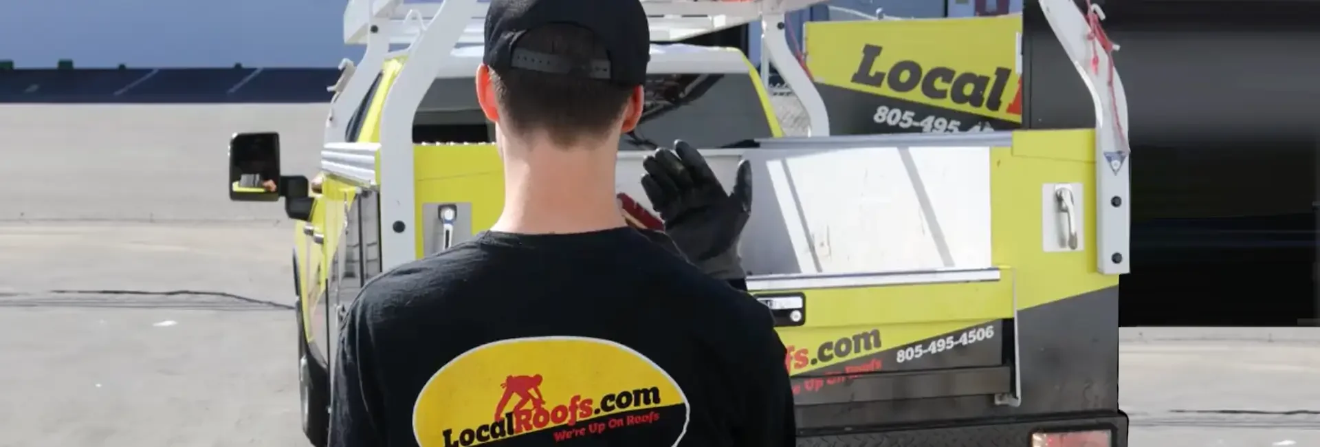 LocalRoofs employee helping a driver back his truck into our warehouse