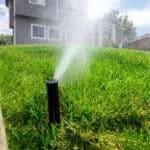 Irrigation system turned on in a residential backyard