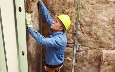 Man installing insulation in central New Mexico