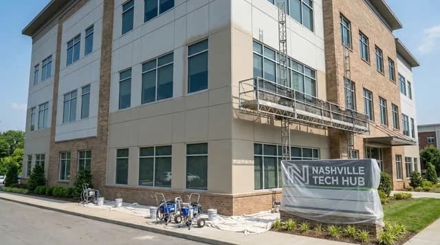 Professional commercial exterior painting on a Nashville office building with fiber cement and brick facade