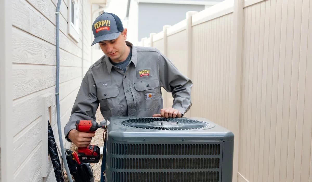 Image of an HVAC technician performing AC maintenance in Boise, Idaho