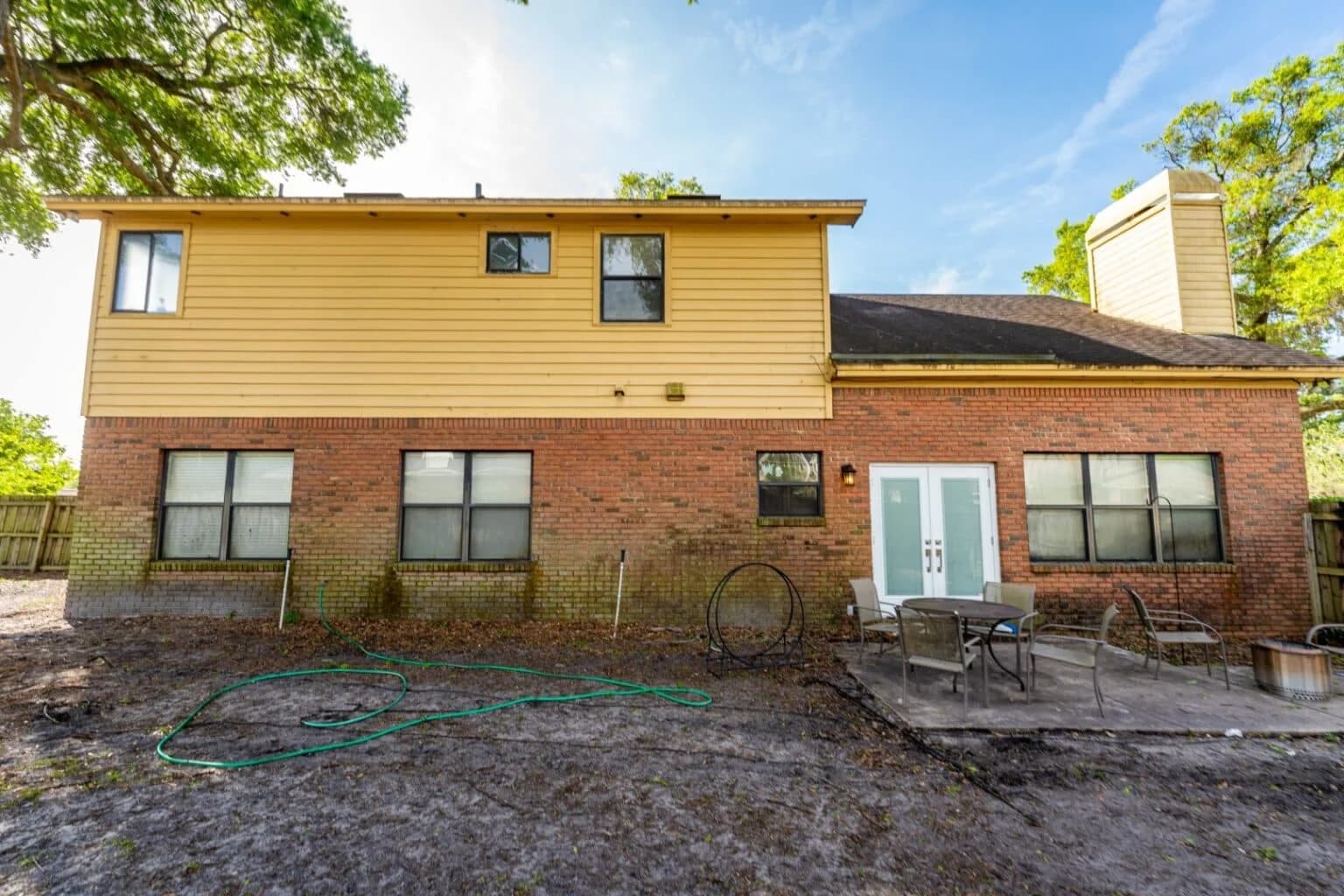 Surface CPR soft washing brick mold from home exterior