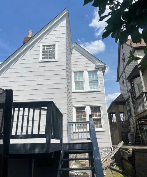 Residential home showcasing new energy-efficient replacement windows and updated siding, emphasizing quality exterior renovations by Alan Construction in Pittsburgh.